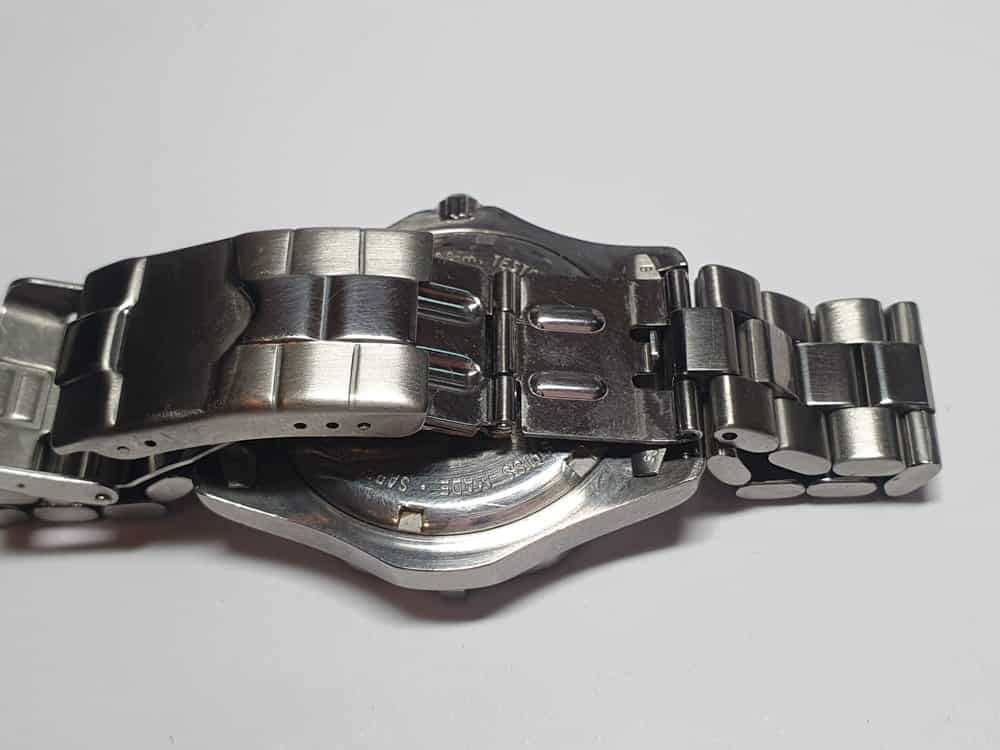 Stainless steel watch clasp and bracelet ready for repair, showing worn links before professional watch bracelet replacement.