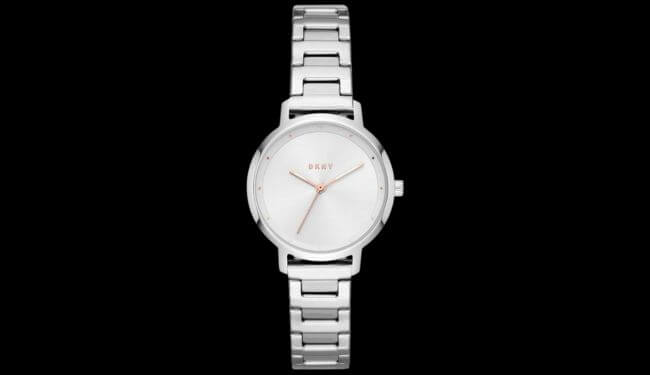 Silver DKNY watch with a white dial on a metal bracelet against a black background