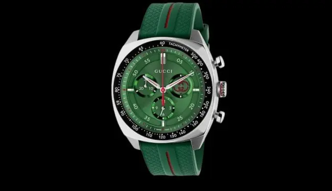 Gucci chronograph watch with a green dial and green strap photographed on a black background