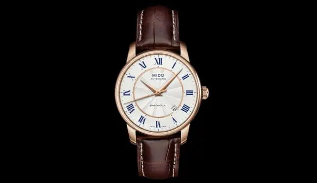 Mido-style white dial watch with brown leather strap on black background – mido watch repairs