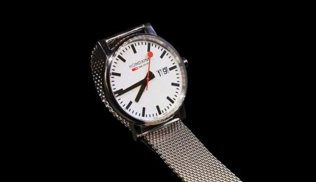 Mondaine-style watch with white dial and mesh strap on black background – mondaine watch repairs