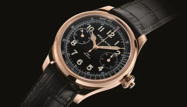 Mont Blanc black dial chronograph watch on black leather strap, angled studio photo
