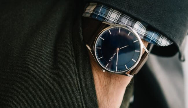 Skagen watch repairs – blue dial Skagen watch with leather strap on wrist