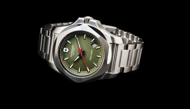 Victorinox stainless steel watch with green dial on metal bracelet for Victorinox watch repairs.