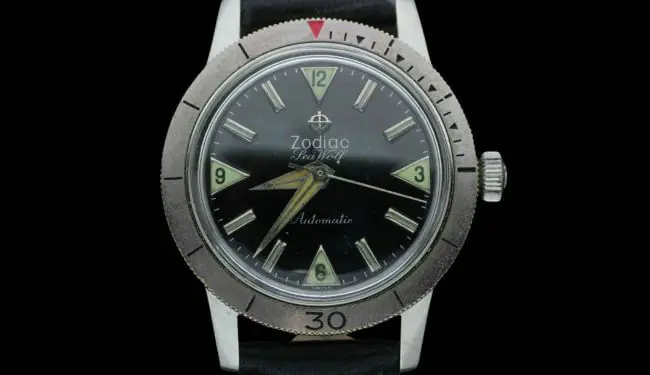 Zodiac wristwatch with a dark dial and stainless steel case on a black background.