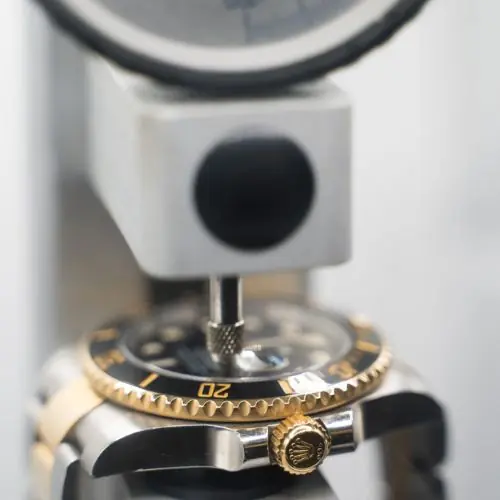Watch being pressure-tested during resealing after a battery replacement