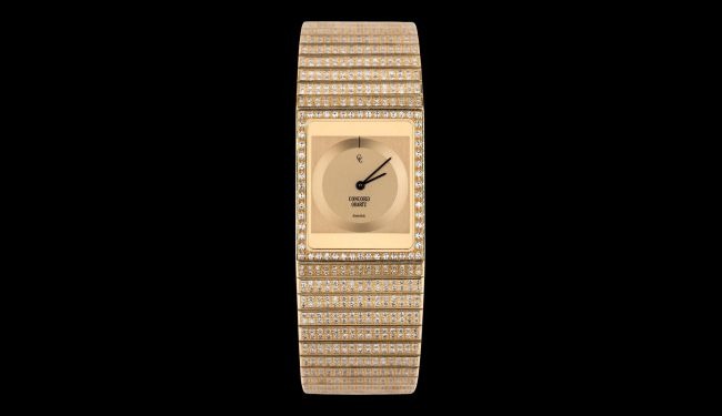 Gold-tone Concord watch with rectangular dial on a black background