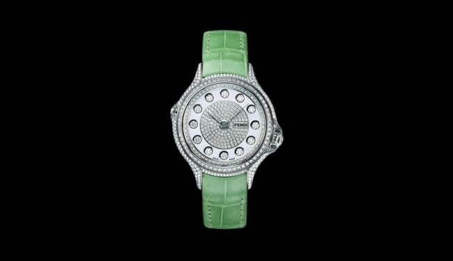 Fendi watch with a light dial and green leather strap against a black background