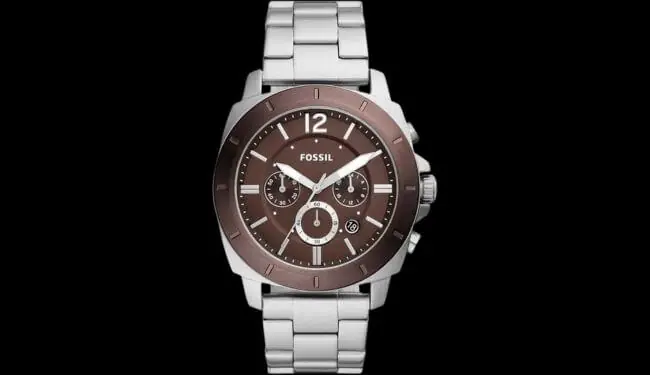Fossil watch with a brown dial on a stainless steel bracelet against a black background