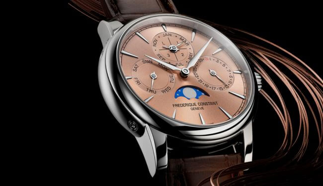 Frederique Constant watch with a champagne dial on a brown leather strap, photographed on a dark background