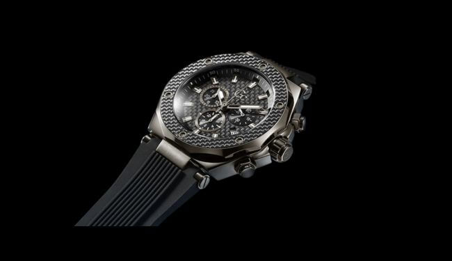 GC watch photographed at an angle showing the case and dial detail on a dark strap against a black background