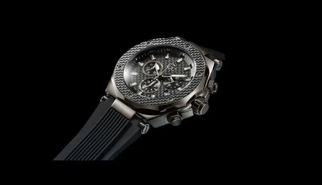 GC watch photographed at an angle showing the case and dial detail on a dark strap against a black background