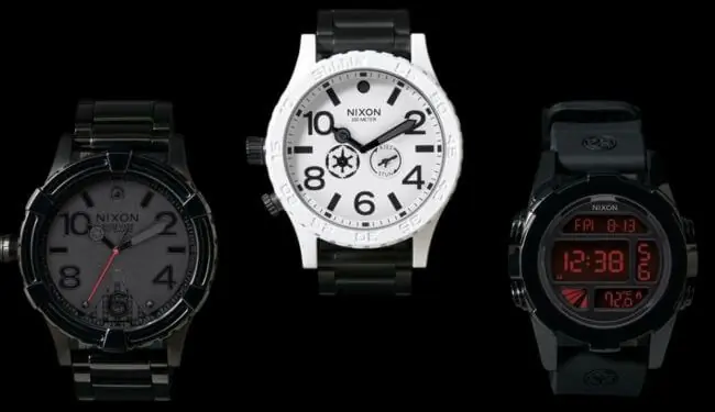 Nixon watch repairs – three Nixon watches on a black background (white dial centre, black models either side)