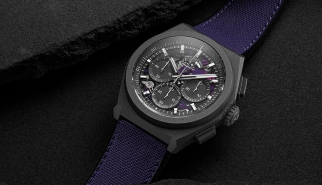 Zenith watch with skeleton dial on a purple strap, shown on a dark background.