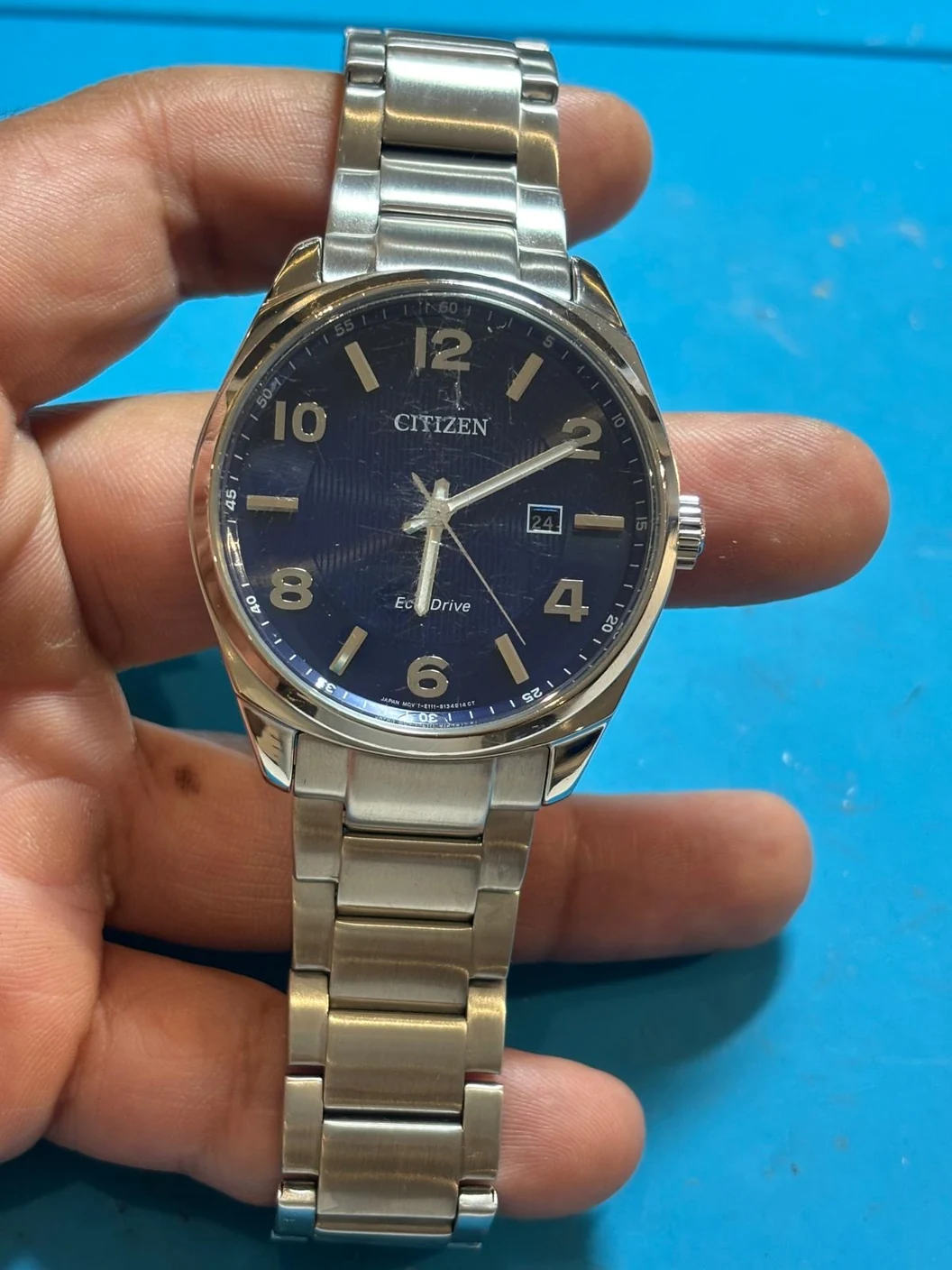 Citizen Eco-Drive E111-S094615 after mini service and polishing; the existing glass scratches remain