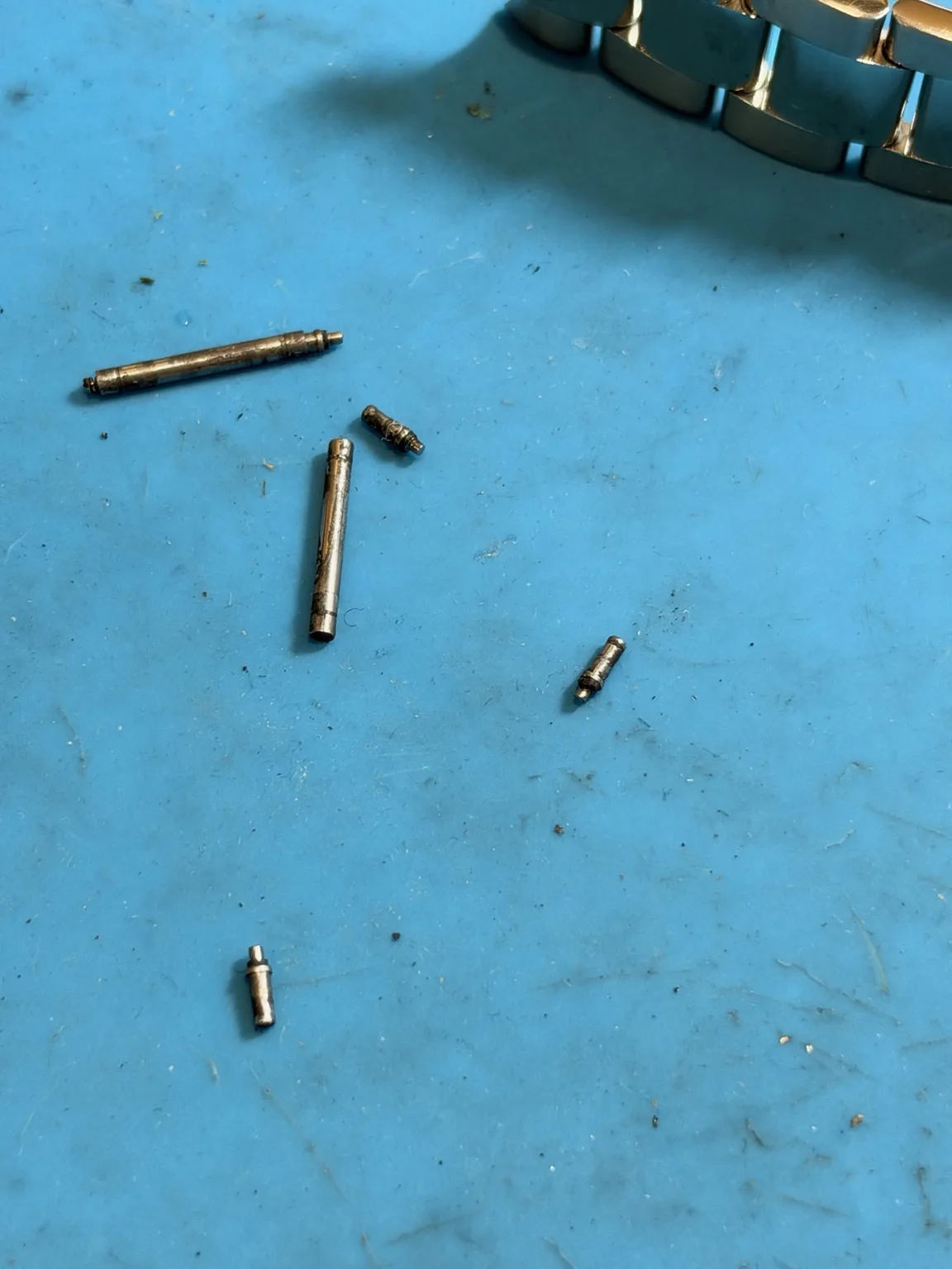 Damaged Rolex 115200 spring bars before repair