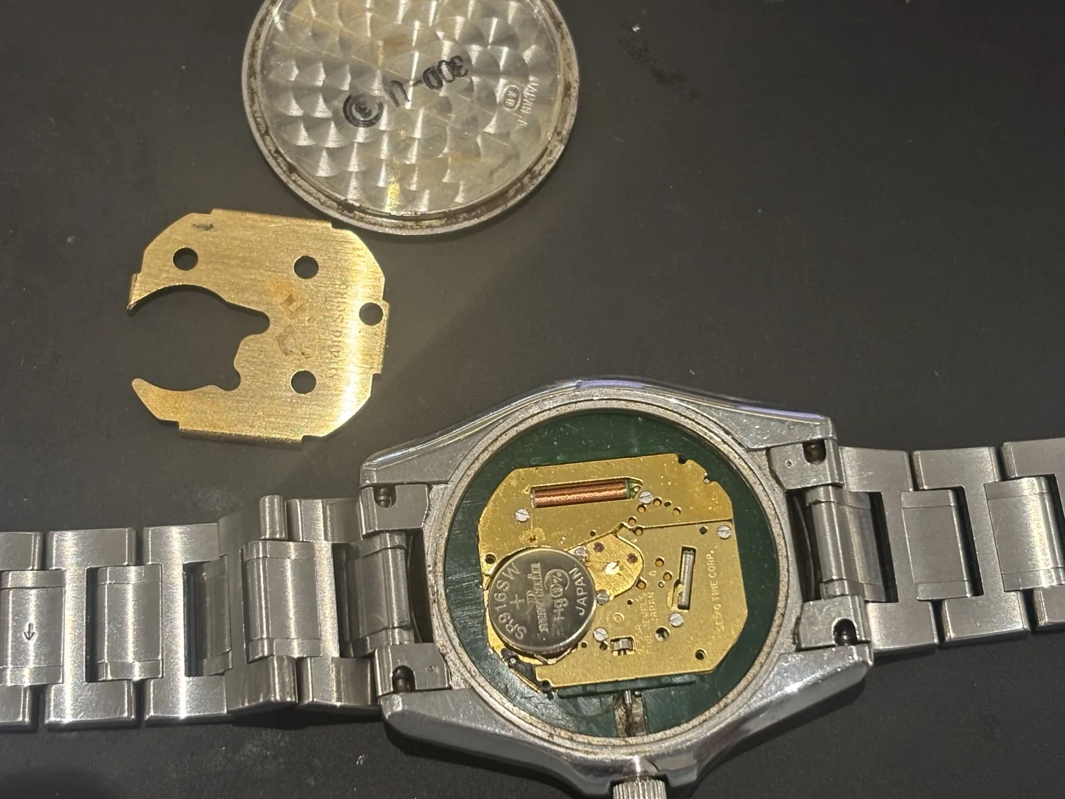 Grand Seiko 8J55 quartz movement and battery visible after the caseback was removed for the missing-gasket reseal